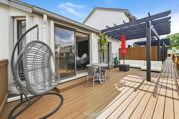 a view of a chairs and table in patio with wooden floor