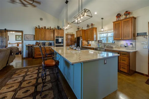 a kitchen with a sink stove and cabinets
