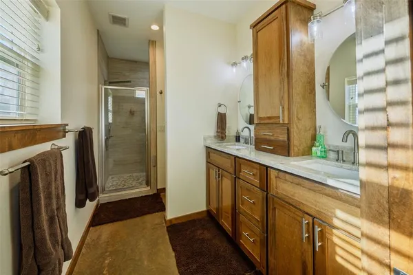 a bathroom with a double vanity sink and a mirror