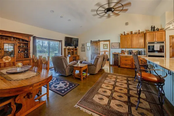 a living room with furniture and a chandelier