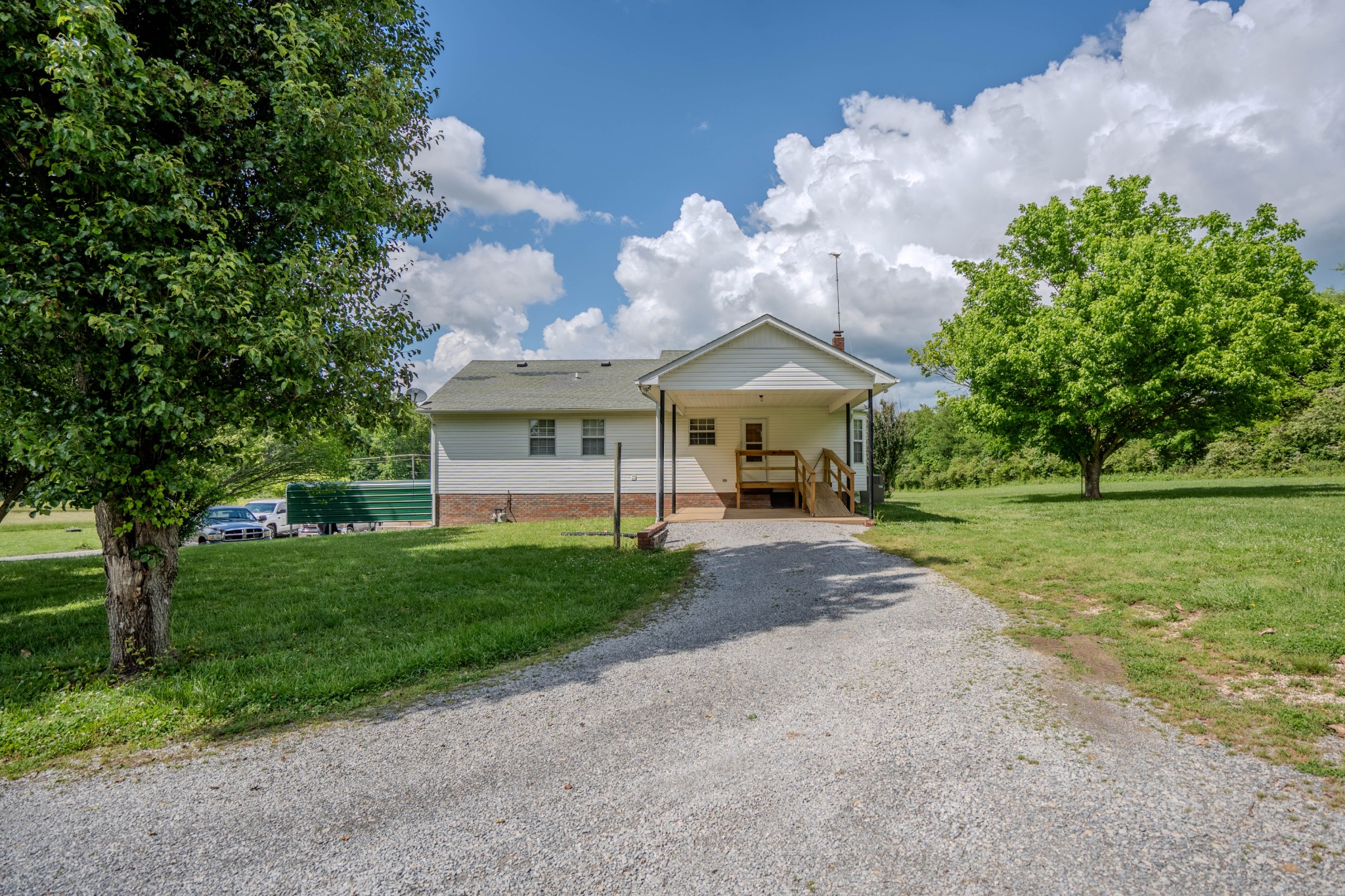 145 Lantz Road Lawrenceburg, TN 38464 - Photo 18 of 42 a view of a house with a yard and a large tree