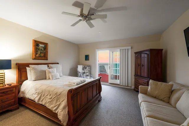a bedroom with a bed couch and window