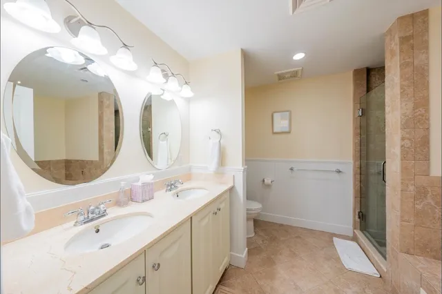 a spacious bathroom with a double vanity sink mirror and double