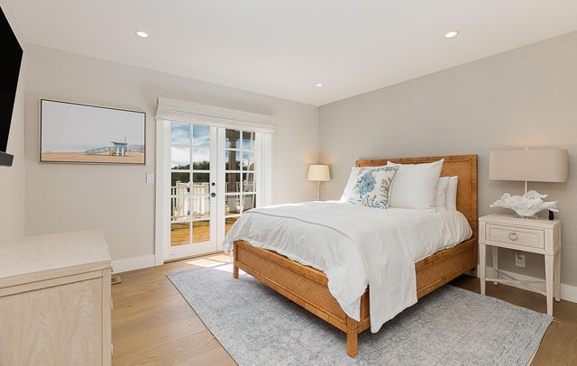 a spacious bedroom with a bed and a large window