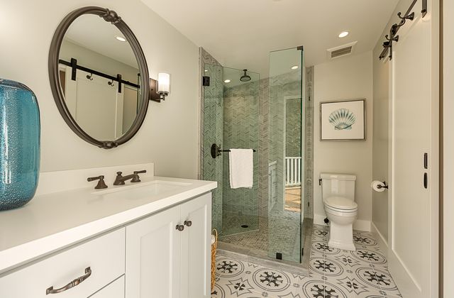 a bathroom with a sink a toilet and shower