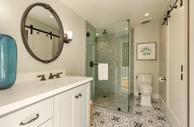 a bathroom with a sink a toilet and shower