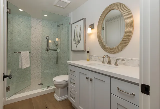 a bathroom with a sink a toilet and a mirror