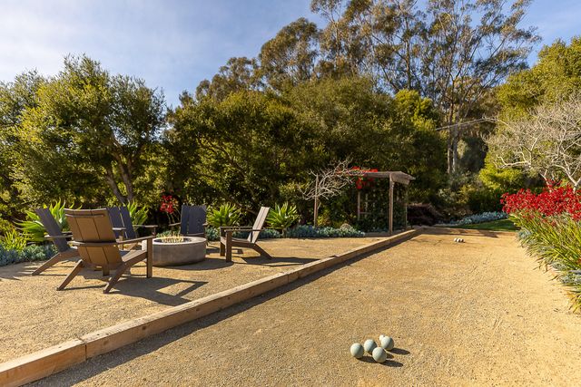 a view of a house with backyard and sitting area
