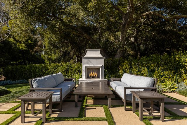 a view of a patio with table and chairs and potted plants with wooden floor and fence