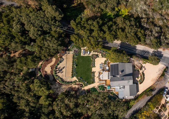 an aerial view of a house with a yard