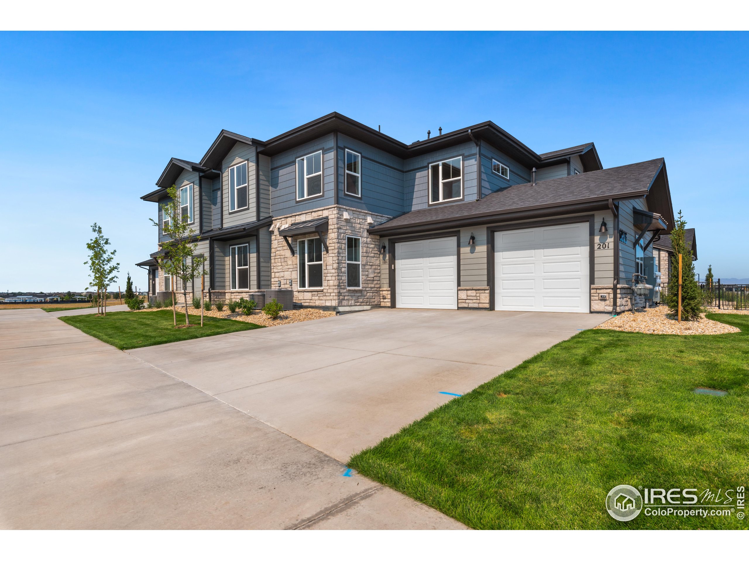 6793 Maple Leaf Drive, Unit 101 Timnath, CO 80547 - Photo 11 of 11 a front view of a house with a yard