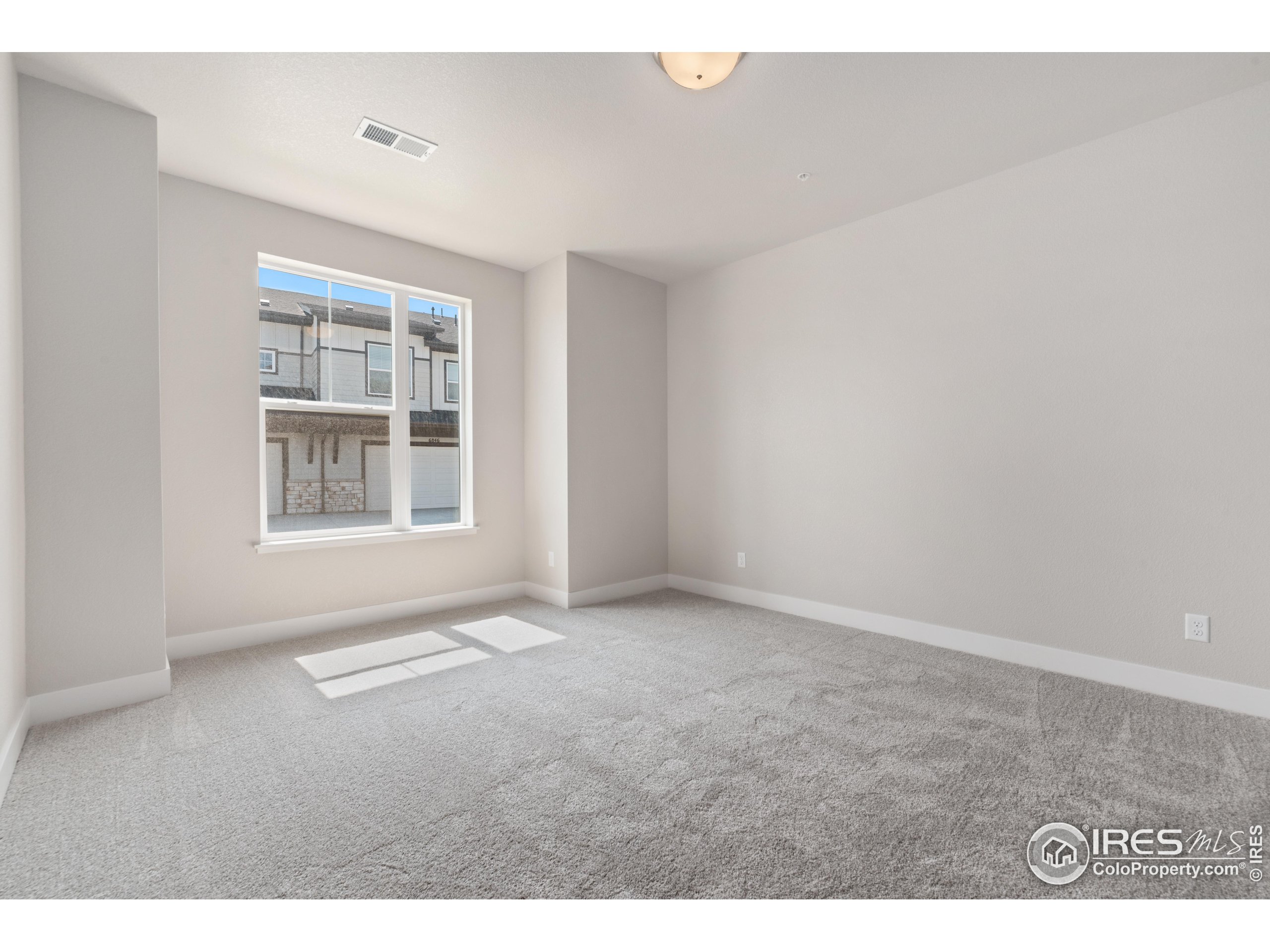 6793 Maple Leaf Drive, Unit 101 Timnath, CO 80547 - Photo 8 of 11 an empty room with windows