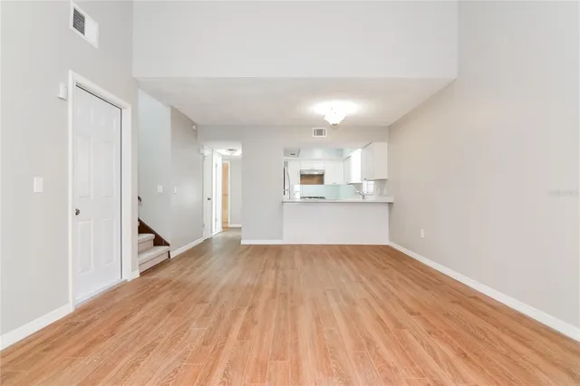 a view of a kitchen with wooden floor and a sink