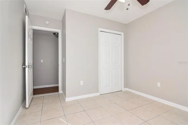 an empty room with cabinet and mirrors