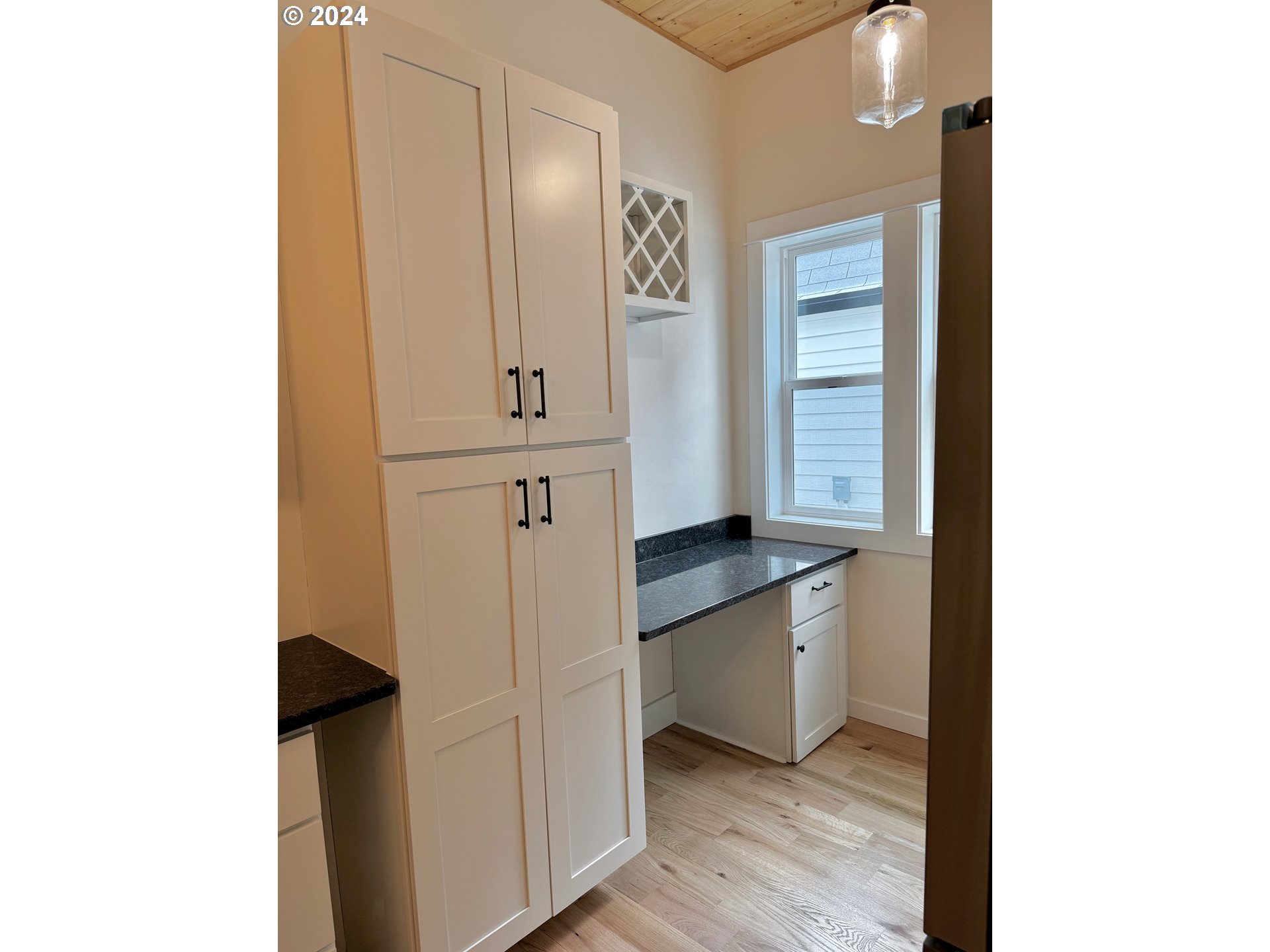 2231 3rd Street Baker City, OR 97814 - Photo 20 of 48 a kitchen with white cabinets and wooden floor