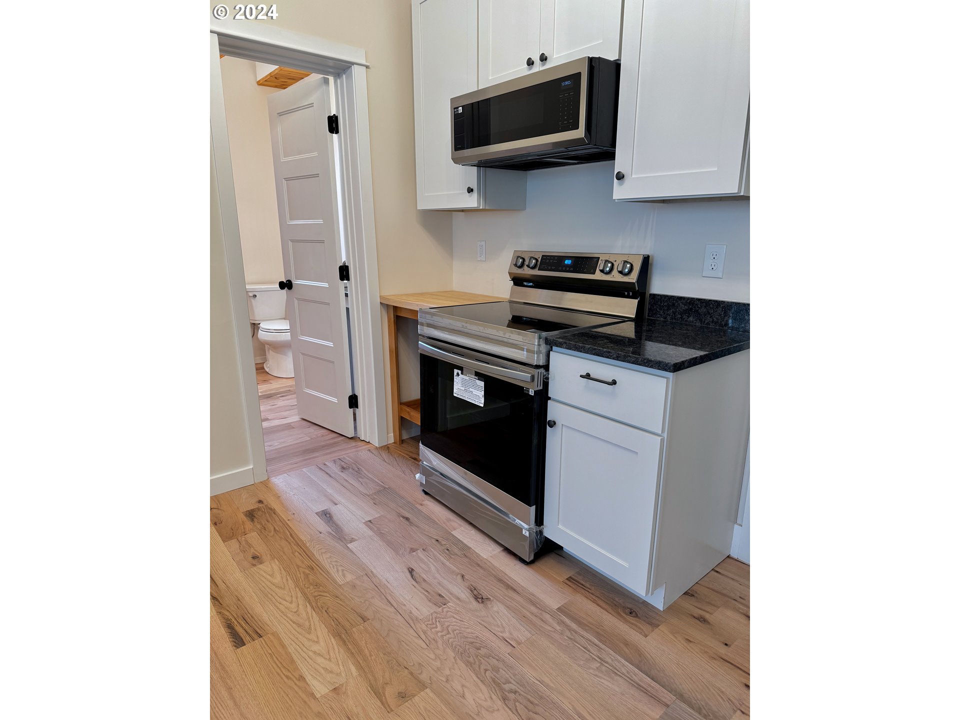 2231 3rd Street Baker City, OR 97814 - Photo 22 of 48 a kitchen with stainless steel appliances a stove microwave and sink