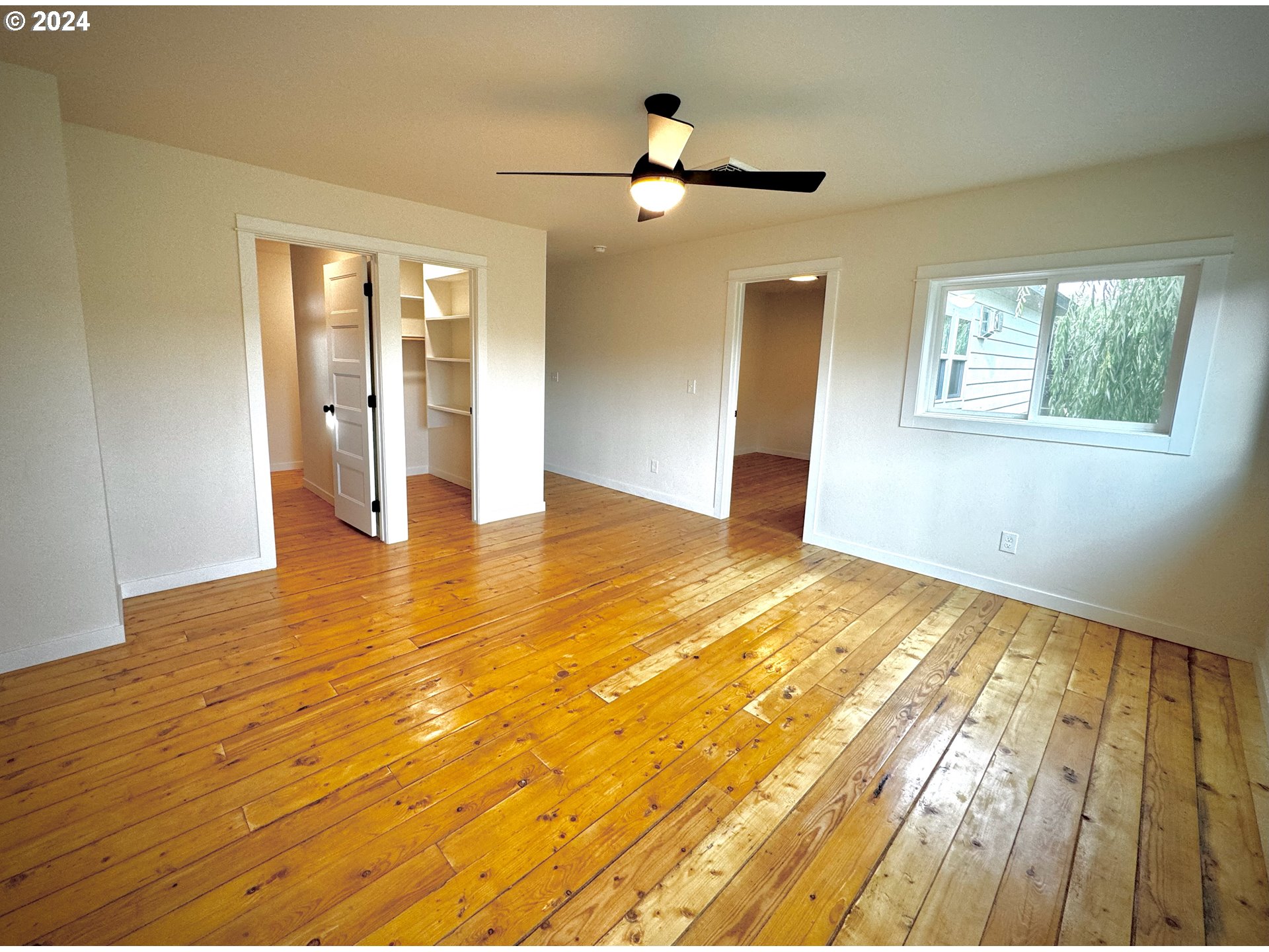 2231 3rd Street Baker City, OR 97814 - Photo 30 of 48 a view of an empty room with wooden floor and a window