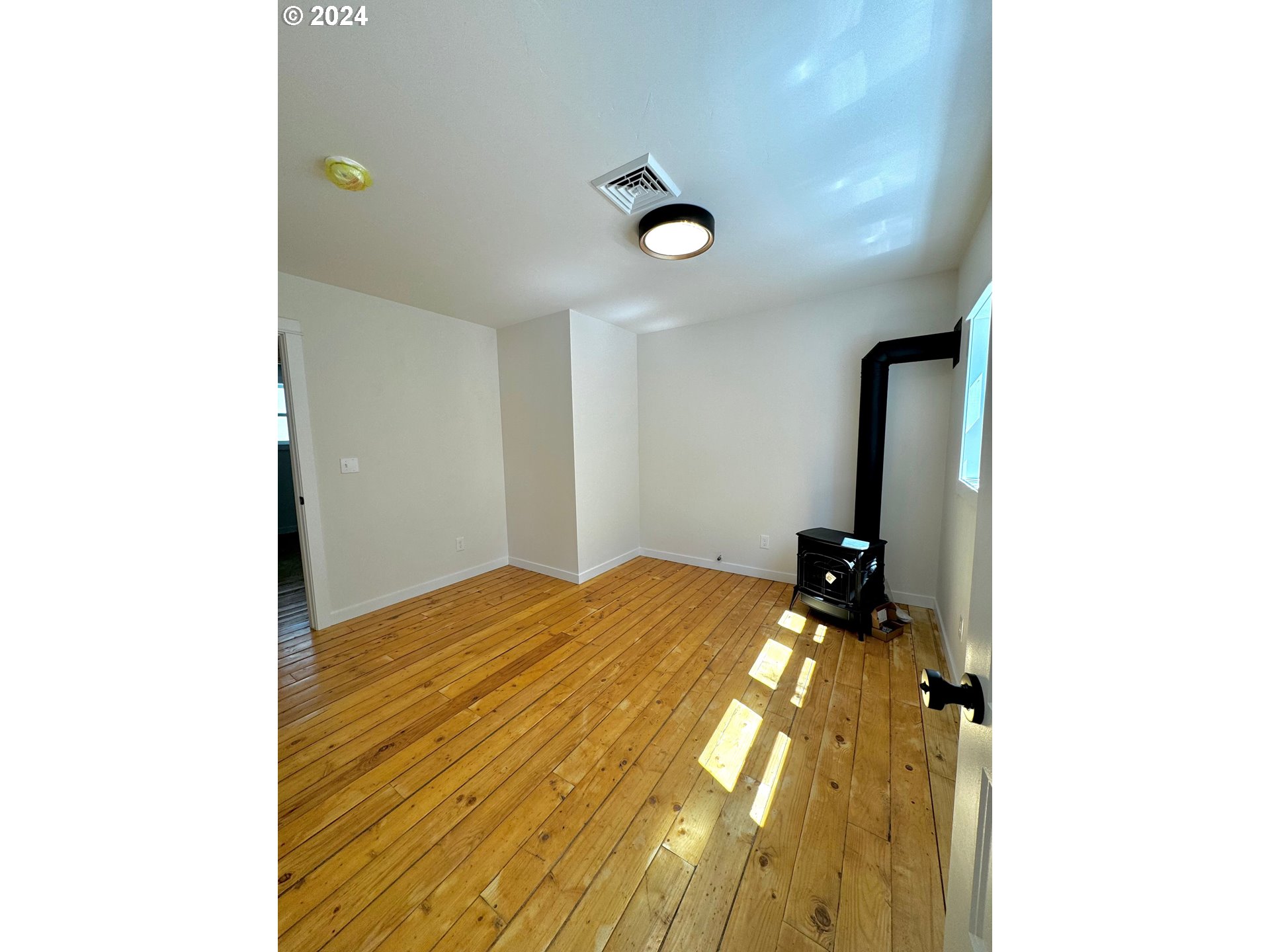 2231 3rd Street Baker City, OR 97814 - Photo 31 of 48 a bedroom with a bed and a chandelier