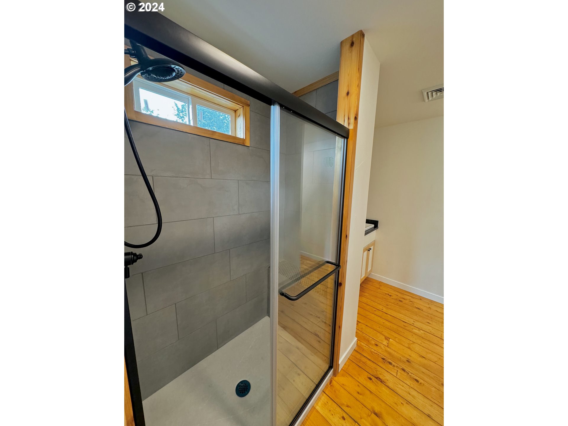 2231 3rd Street Baker City, OR 97814 - Photo 32 of 48 a bathroom with a shower and a sink