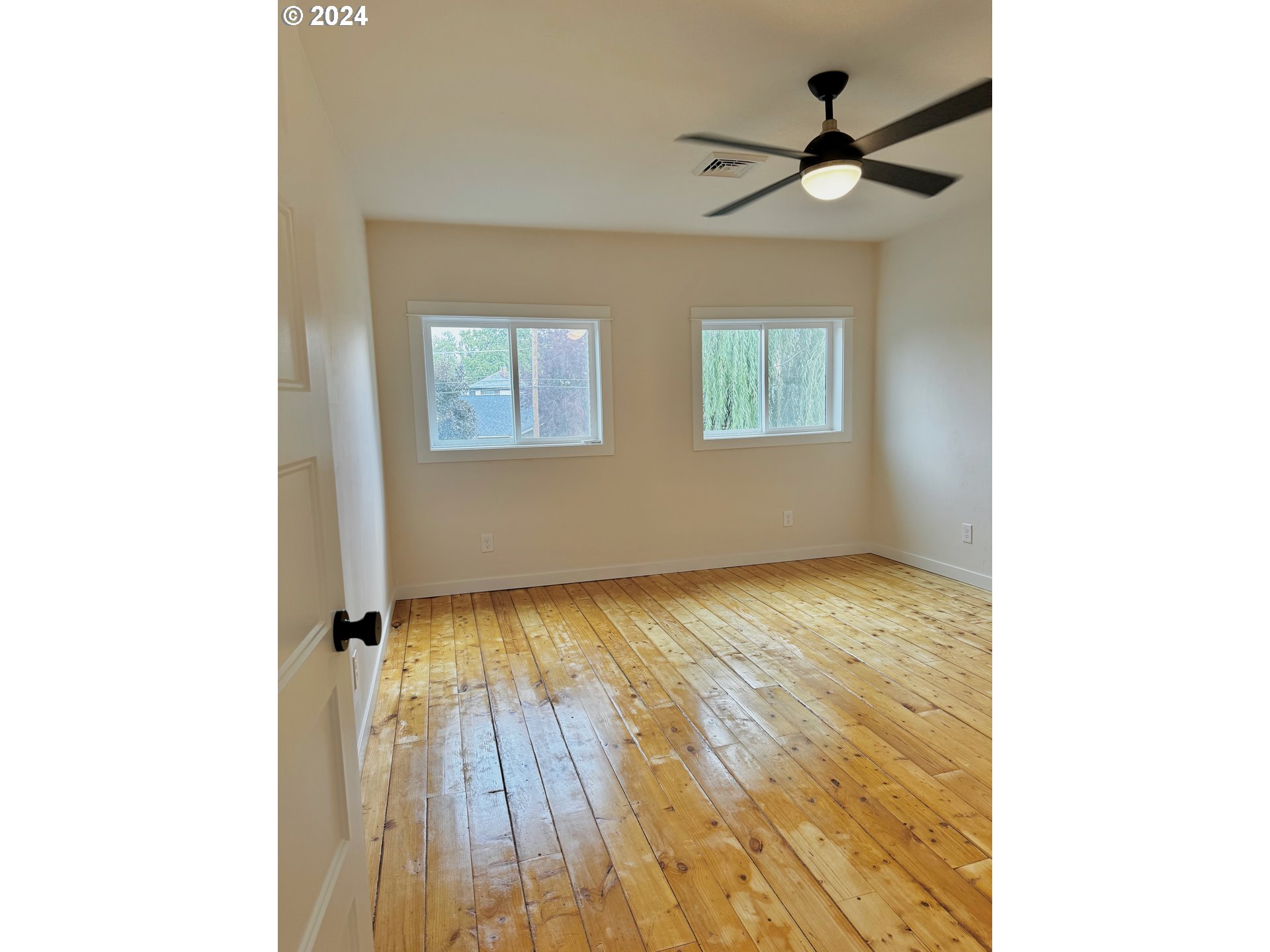 2231 3rd Street Baker City, OR 97814 - Photo 37 of 48 a view of an empty room with wooden floor and a window