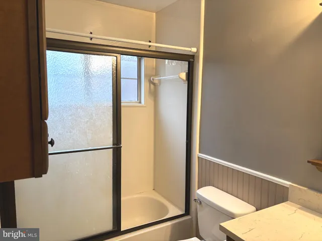 a bathroom with a glass shower door