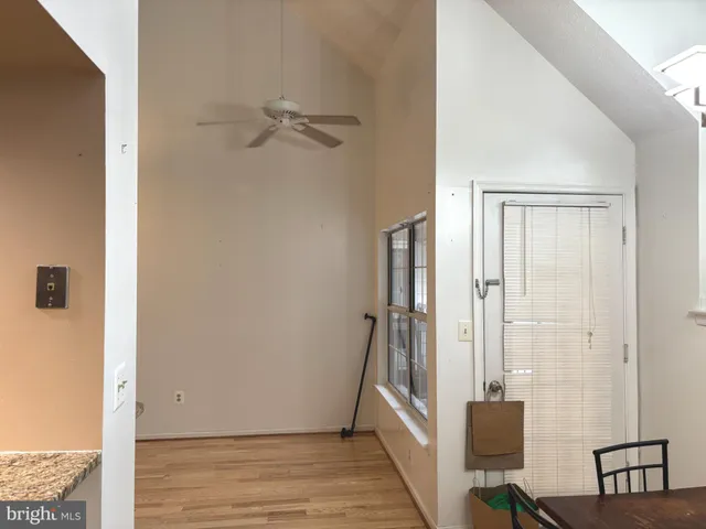 a view of a hallway with wooden floor and entryway