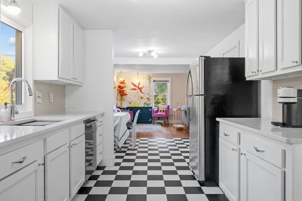 18 Carlton Road Bourne, MA 02532 - Photo 13 of 41 a kitchen with a sink a refrigerator and cabinets