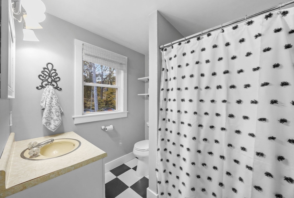 18 Carlton Road Bourne, MA 02532 - Photo 21 of 41 a bathroom with a sink toilet a mirror and shower