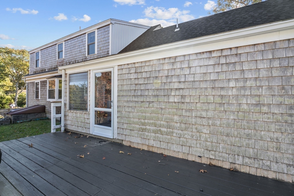 18 Carlton Road Bourne, MA 02532 - Photo 29 of 41 a view of a house with a small yard and wooden fence