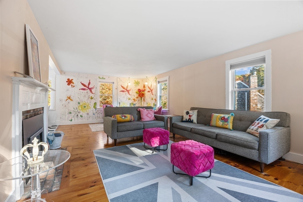 18 Carlton Road Bourne, MA 02532 - Photo 6 of 41 a living room with furniture toys and a fireplace