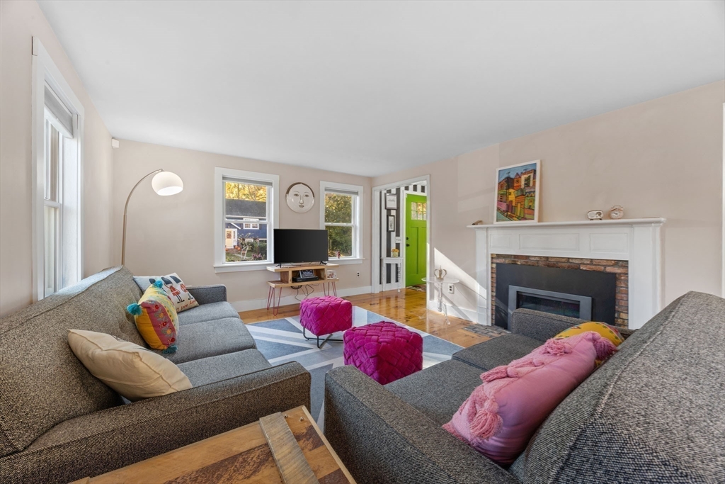 18 Carlton Road Bourne, MA 02532 - Photo 7 of 41 a living room with furniture a flat screen tv and a fireplace