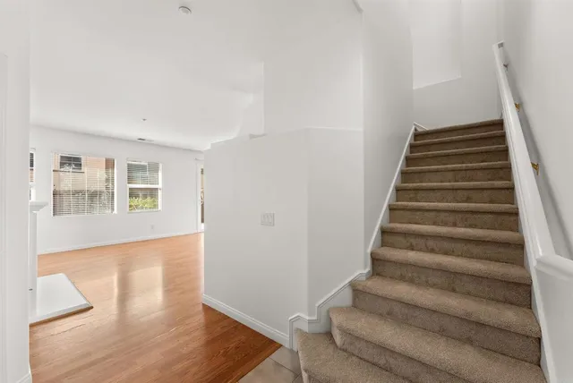 a view of an entryway with wooden floor