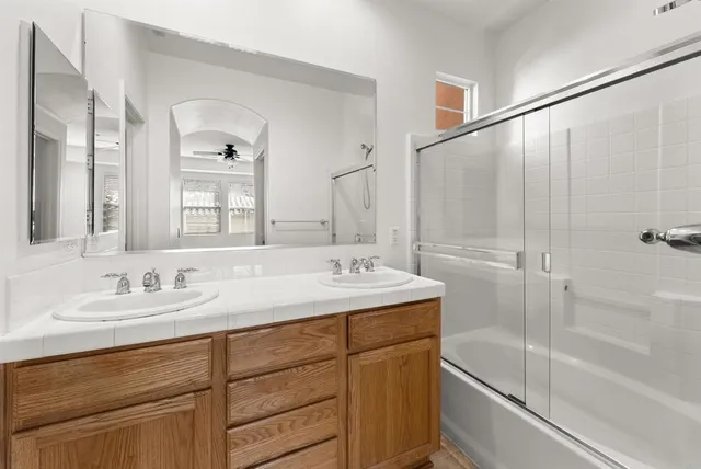 a bathroom with a shower and a sink