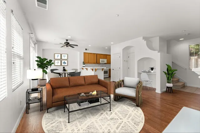a living room with furniture fireplace and wooden floor