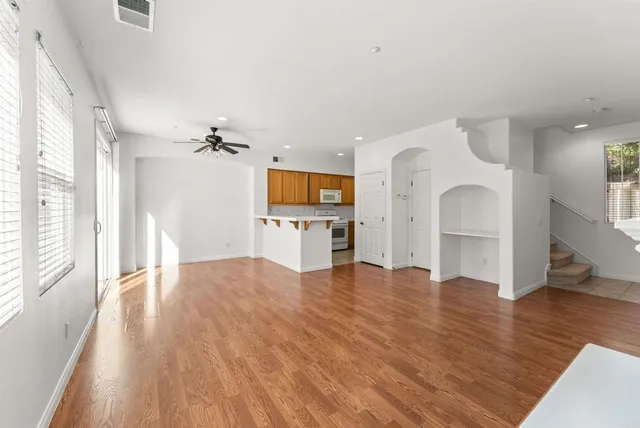 a view of a kitchen with furniture and wooden floor