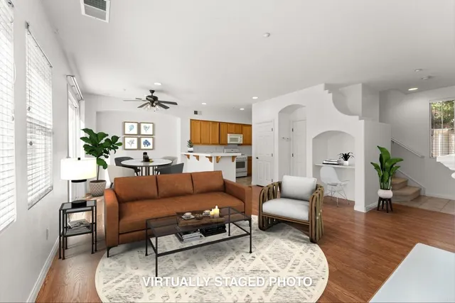 a living room with furniture a fireplace and wooden floor