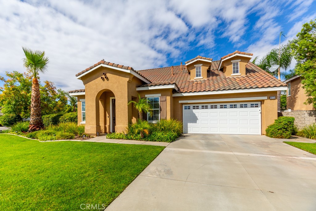 a front view of a house with a yard and garage