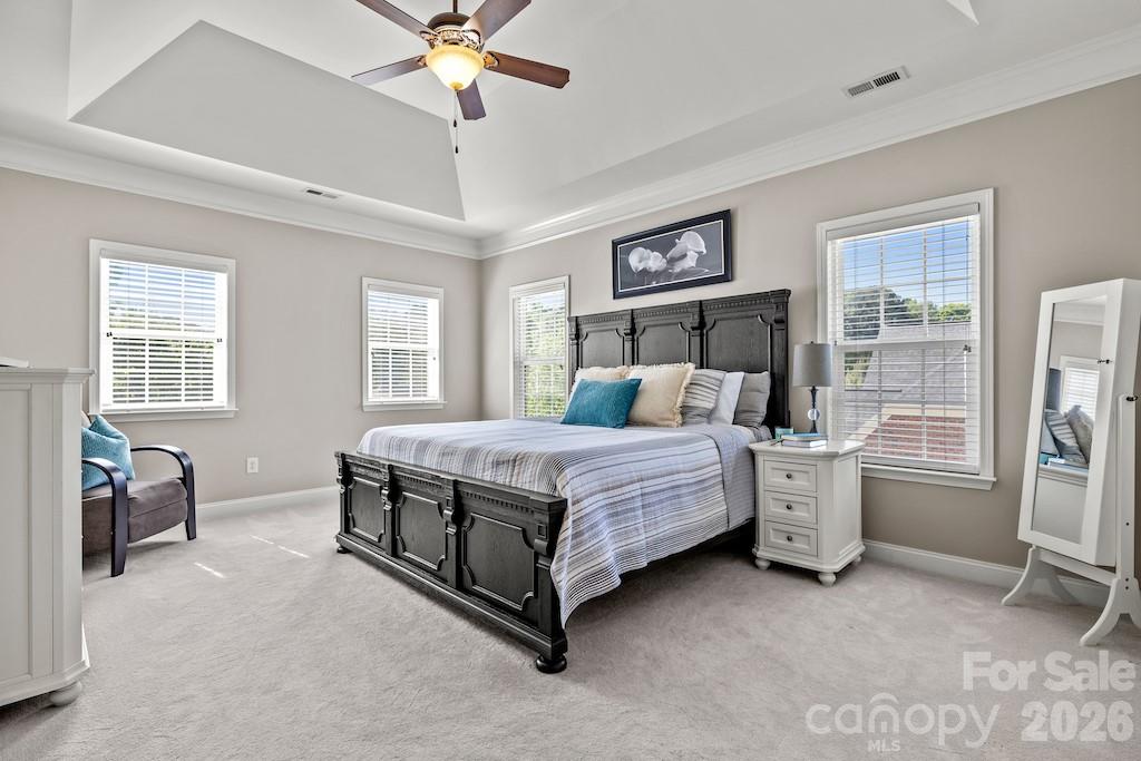 4145 Summit Ridge Lane Denver, NC 28037 - Photo 31 of 47 a bedroom with a bed and a chandelier