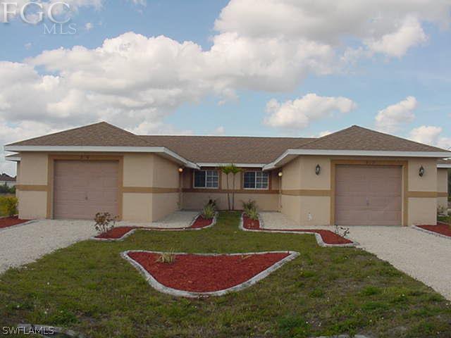 717 Alabama Road South Lehigh Acres, FL 33974 - Photo 1 of 9 front view of house with a yard