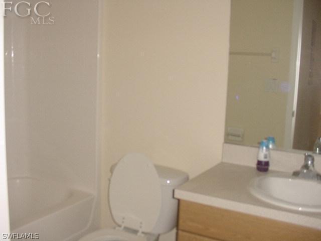 717 Alabama Road South Lehigh Acres, FL 33974 - Photo 7 of 9 a bathroom with a sink and a mirror
