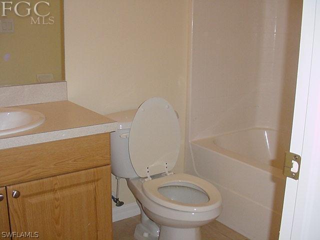 717 Alabama Road South Lehigh Acres, FL 33974 - Photo 8 of 9 a bathroom with a sink and a toilet