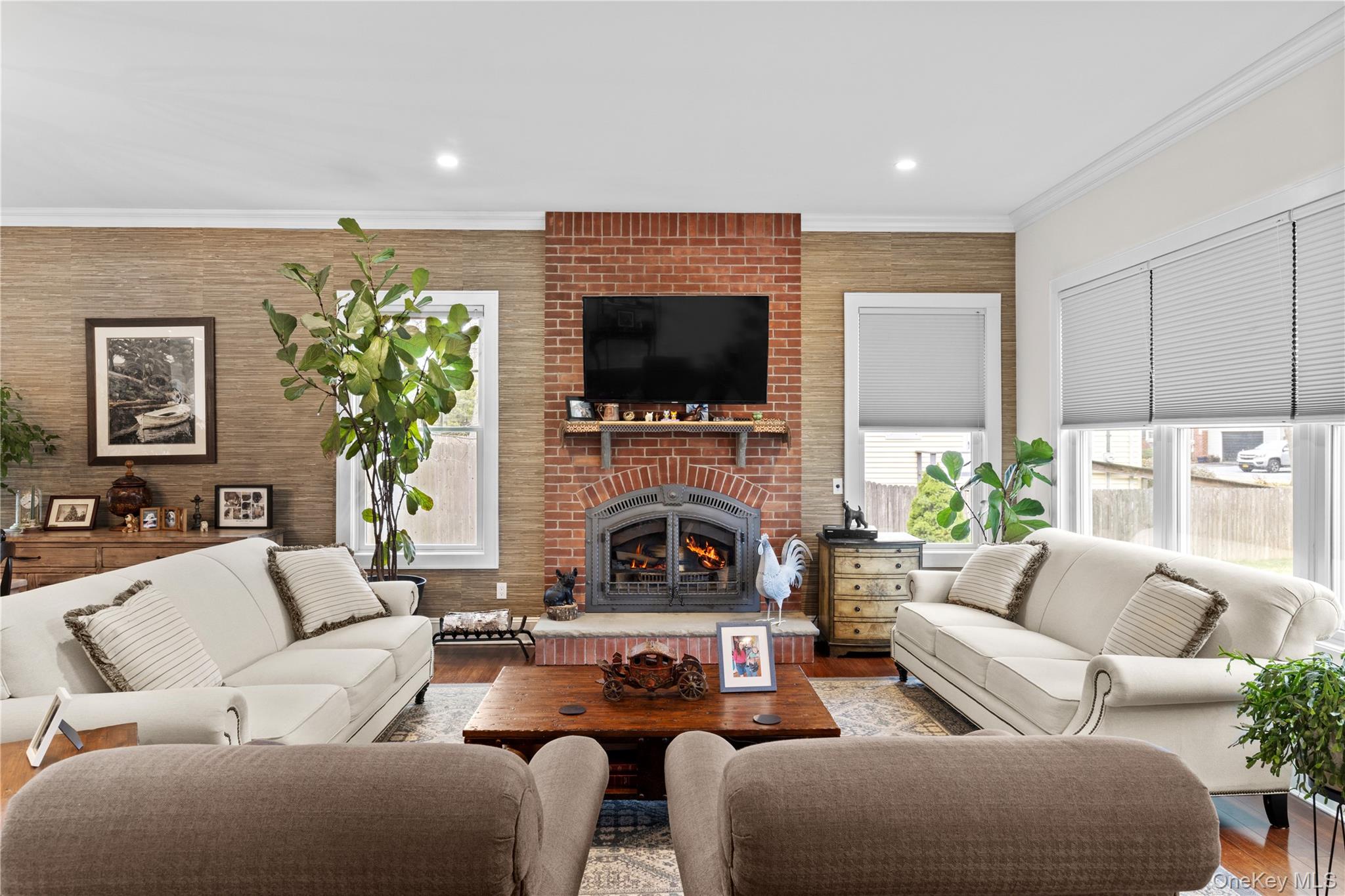 360 Masters Road Laurel, NY 11948 - Photo 12 of 49 a living room with furniture a flat screen tv and a fireplace