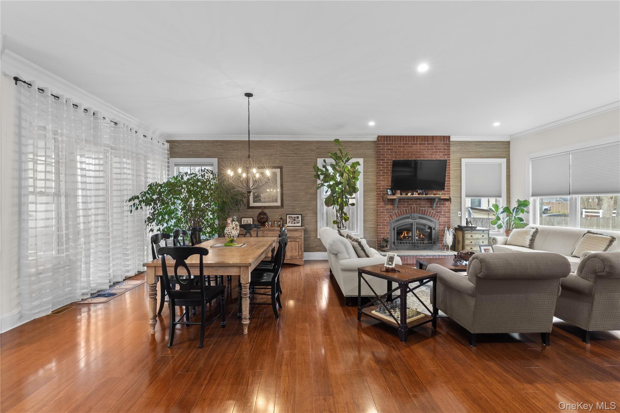 360 Masters Road Laurel, NY 11948 - Photo 13 of 49 a living room with furniture a fireplace and a flat screen tv
