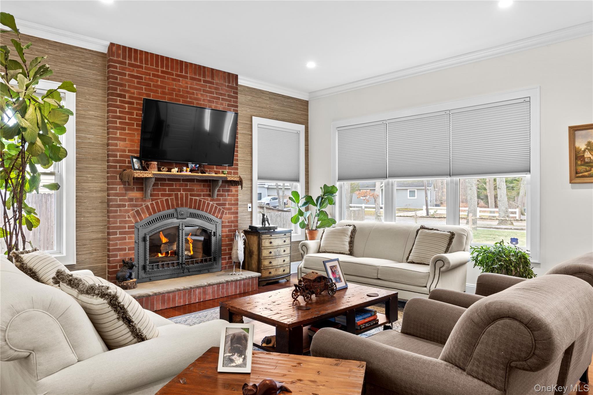 360 Masters Road Laurel, NY 11948 - Photo 15 of 49 a living room with furniture a flat screen tv and a fireplace