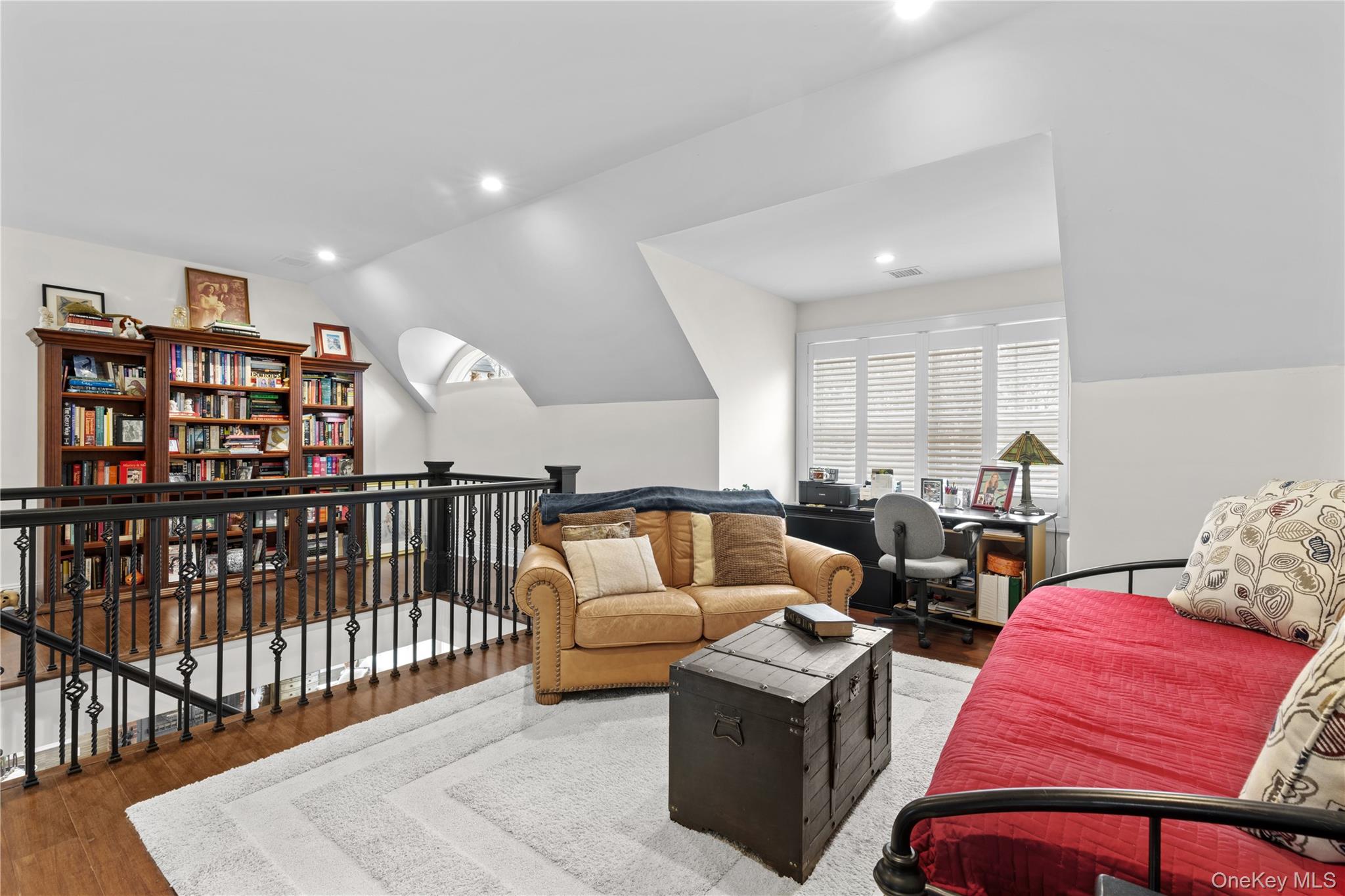 360 Masters Road Laurel, NY 11948 - Photo 29 of 49 a living room with furniture a rug and a book shelf
