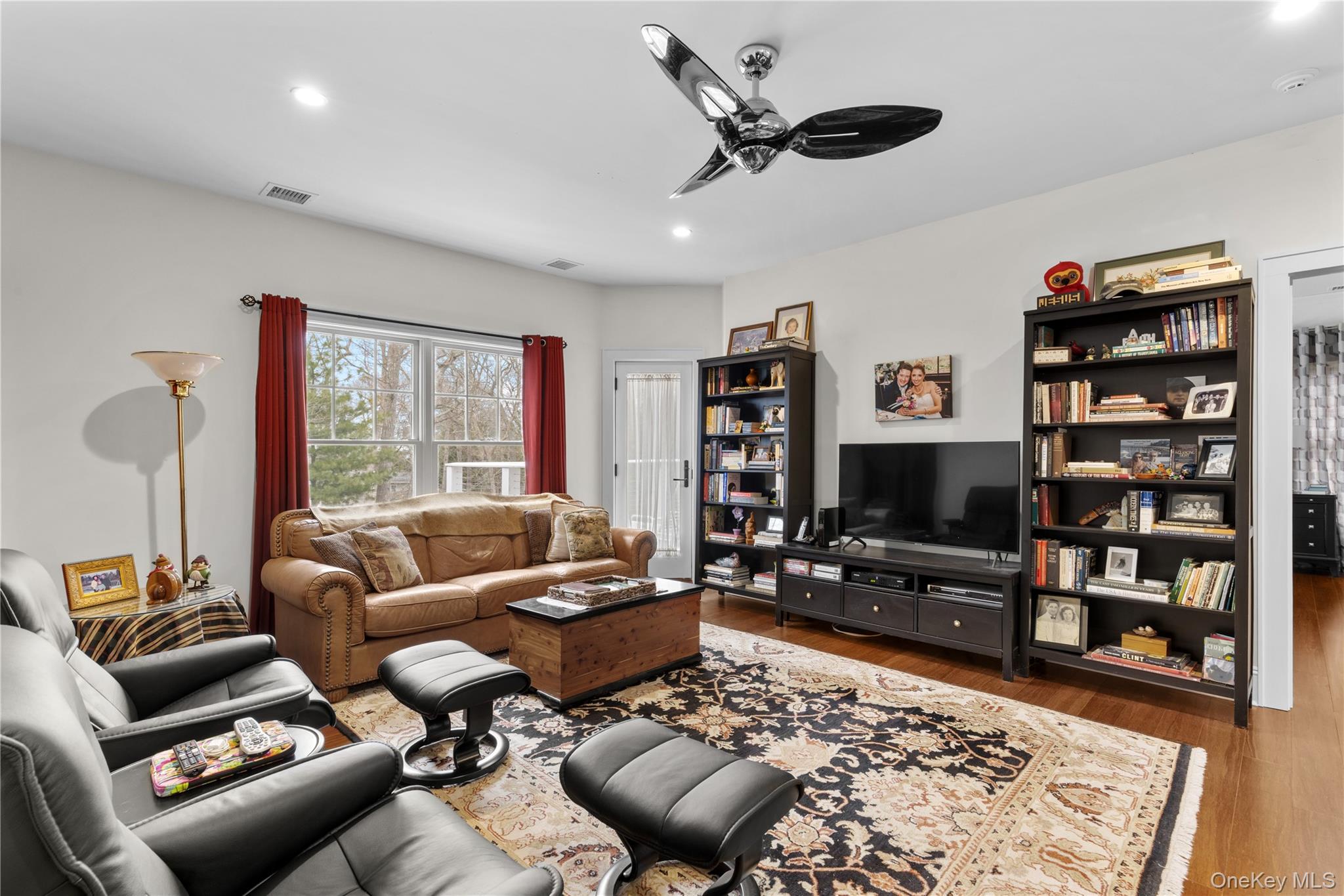 360 Masters Road Laurel, NY 11948 - Photo 32 of 49 a living room with furniture a rug and a flat screen tv
