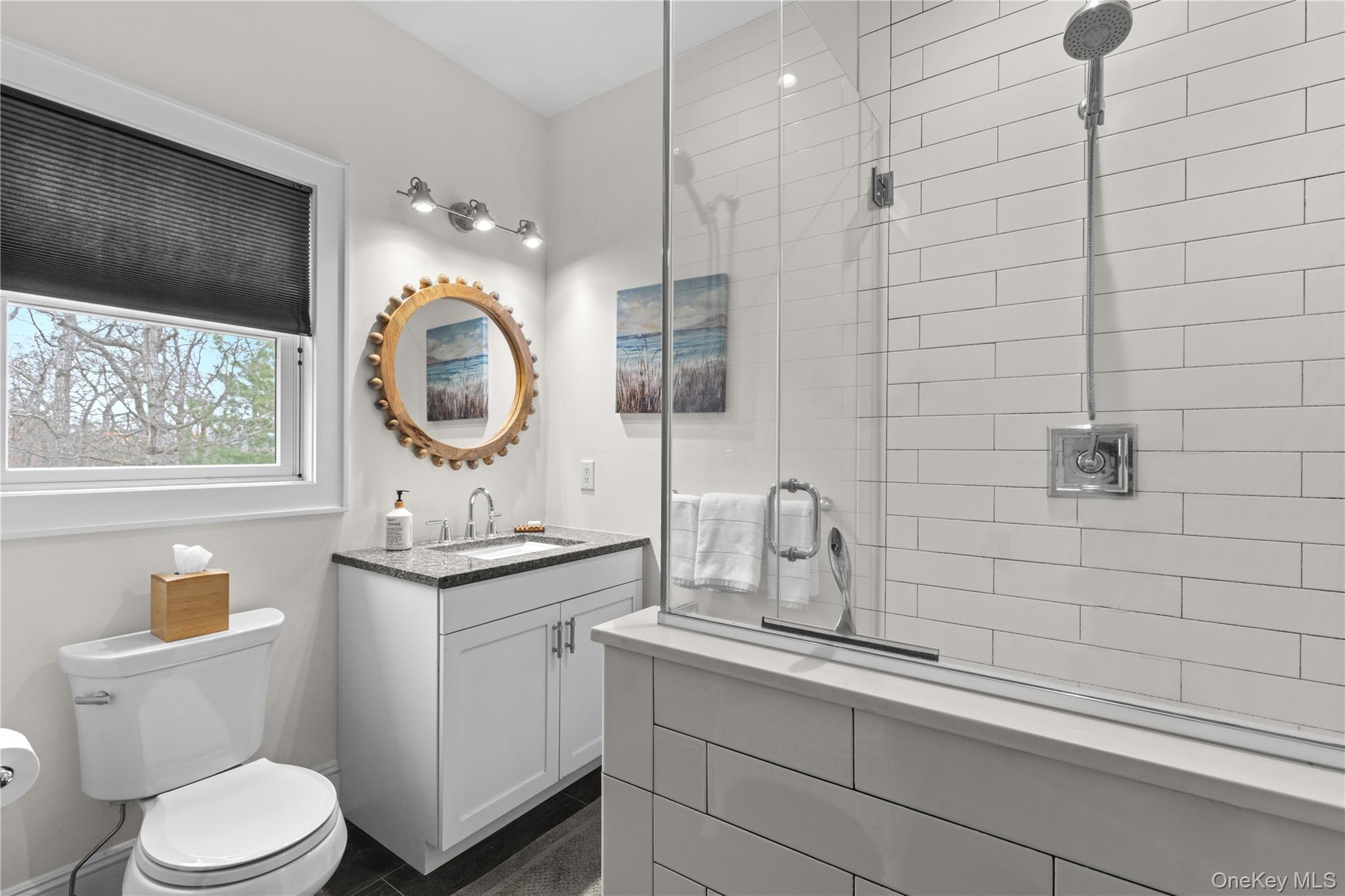 360 Masters Road Laurel, NY 11948 - Photo 42 of 49 a bathroom with a toilet sink and mirror