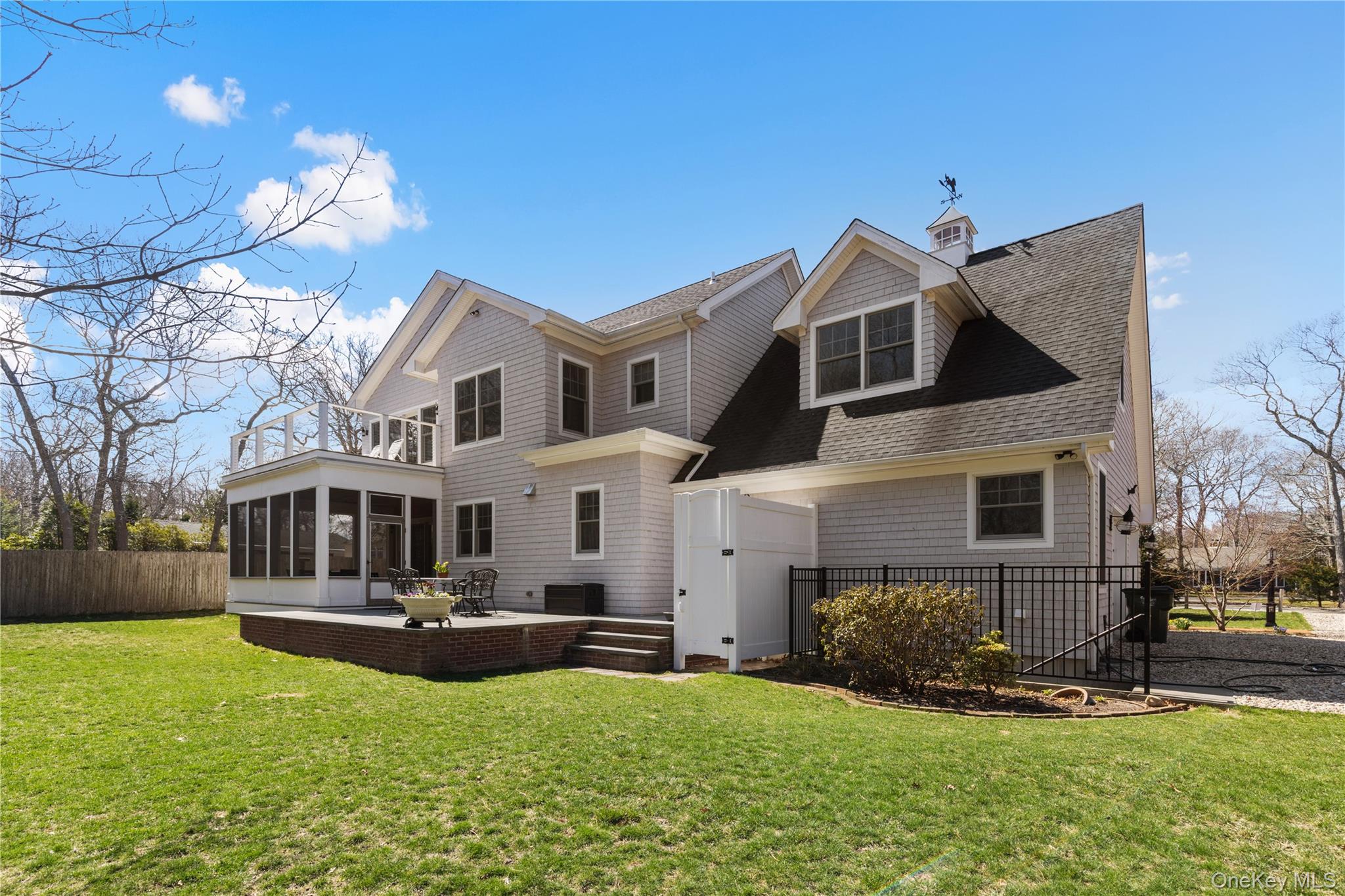 360 Masters Road Laurel, NY 11948 - Photo 45 of 49 a front view of a house with a yard table and chairs