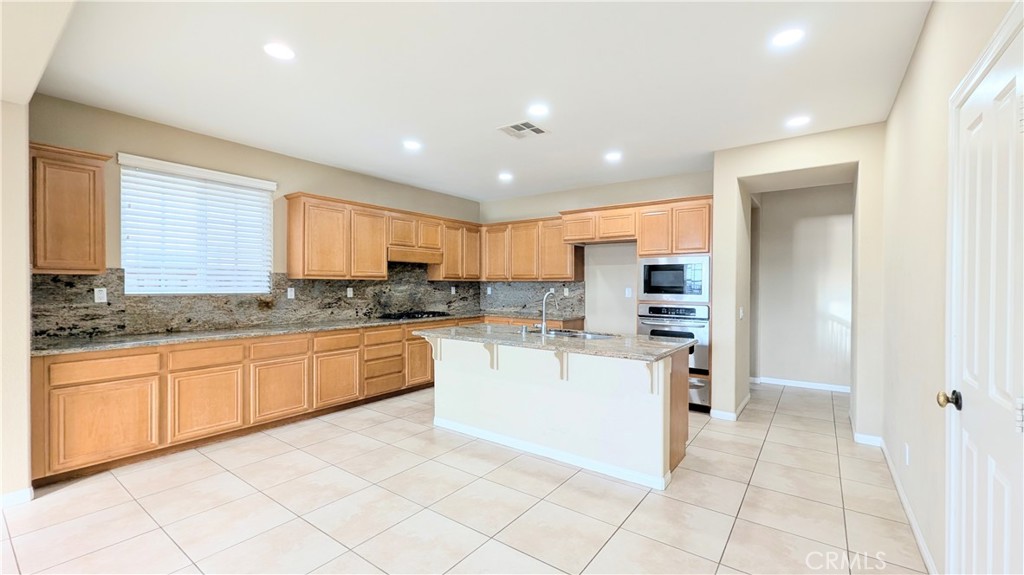 1169 Parkview Drive Oceanside, CA 92057 - Photo 4 of 27 a large kitchen with stainless steel appliances granite countertop a large counter top and a stove top oven
