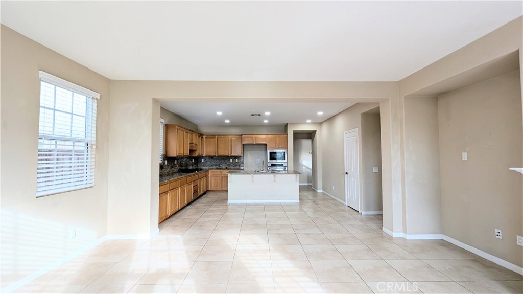 1169 Parkview Drive Oceanside, CA 92057 - Photo 6 of 27 a view of a kitchen with kitchen island a refrigerator a sink dishwasher with a dining table and chairs